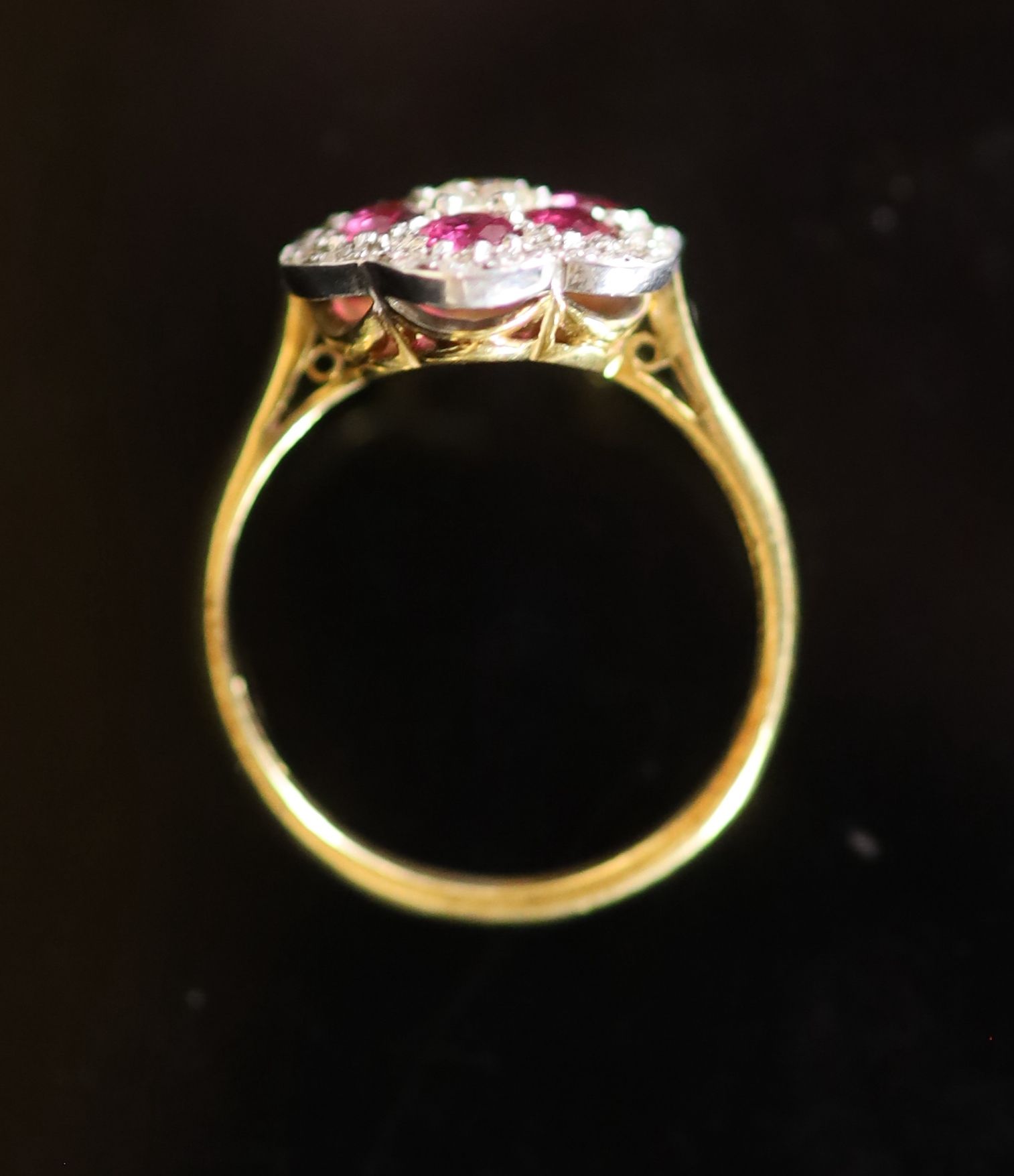 A modern 18ct gold, ruby and diamond set flower head cluster ring